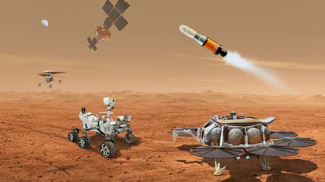 a red desert landscape with five different shaped robots and a moon in the background