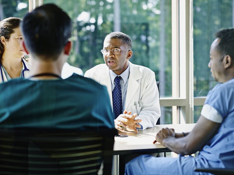Health care providers sitting at conference table