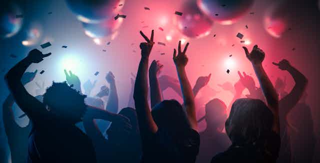 Graphic image of people dancing in a club against a pink and blue lit ceiling.