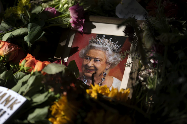 Floral tributes around framed photo of Queen Elizabeth
