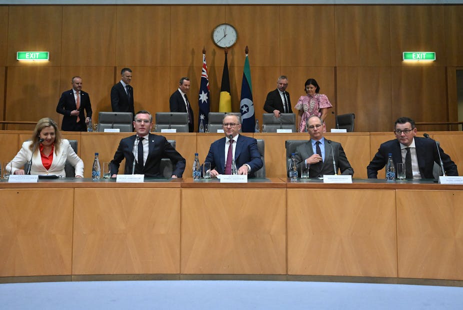 Prime Minister and state ministers sitting at a large desk