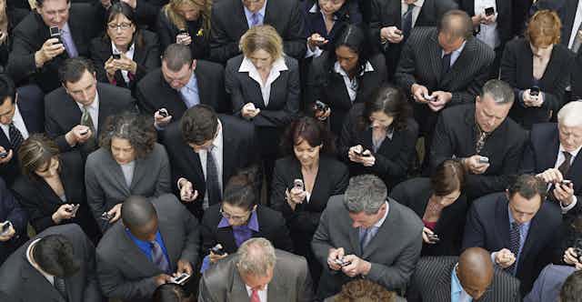 Crowd of people using phones