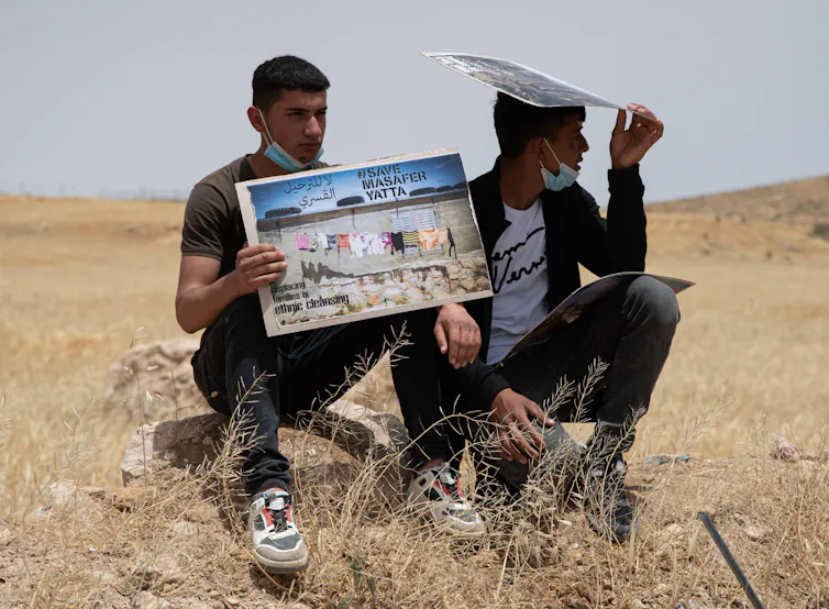 Two young men with placards