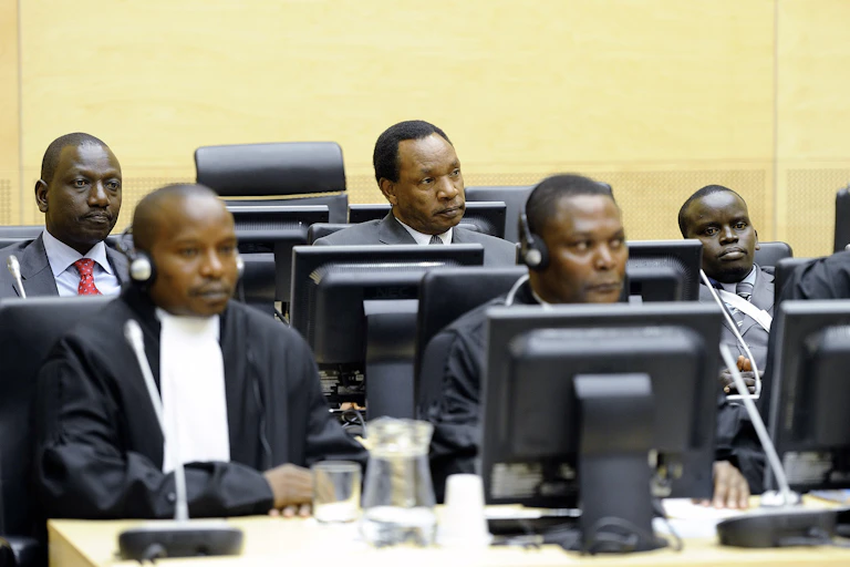 Three Kenyans being charged in connection with electoral violence sit in a criminal court