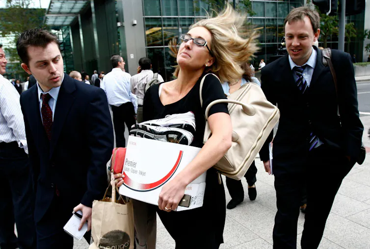 Woman carrying box of possessions.
