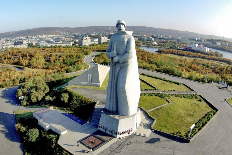 A large white monument of a man in robes.