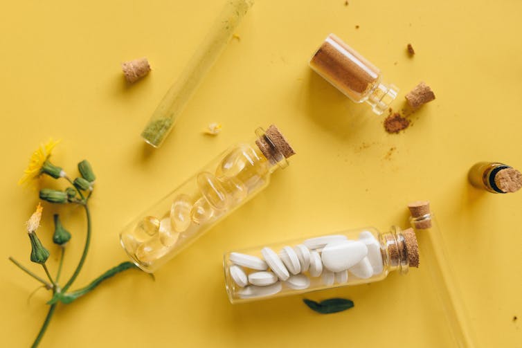 herbs and pills in glass bottles