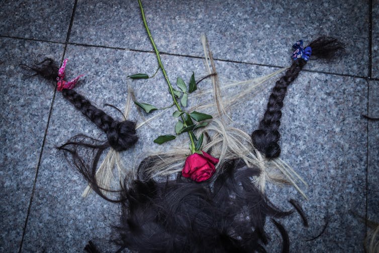 A pile of hair cut by Iranian women and a rose during a protest following the death of Iranian Mahsa Amini, in Istanbul, Turkey, 02 October 2022.