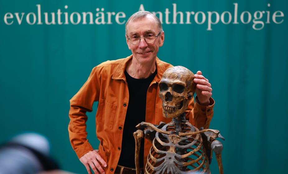 Nobel prize winner Svante Paabo poses with a skeleton.