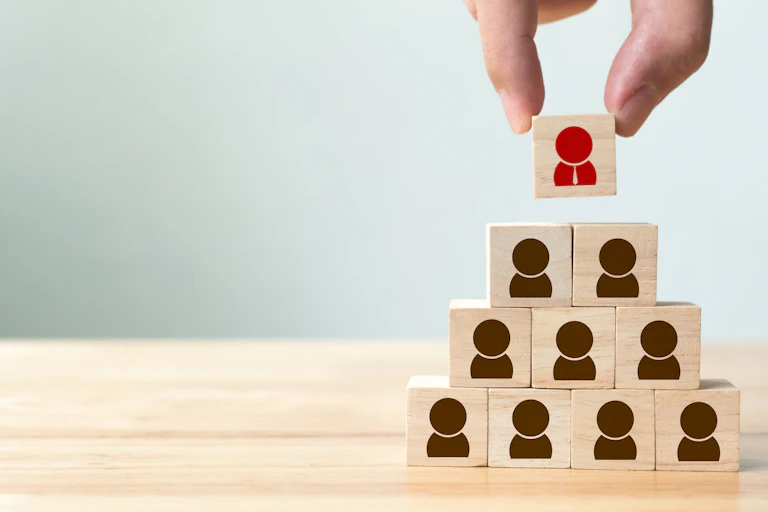 Pyramid of wooden blocks with person icon