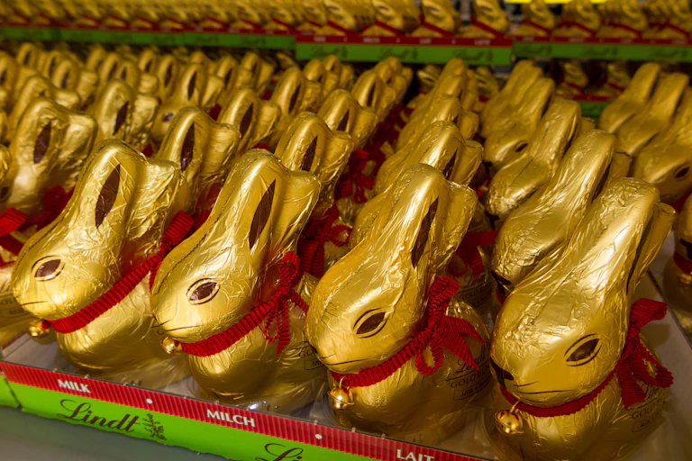 A shelf of milk chocolate Lindt Gold Bunnies.