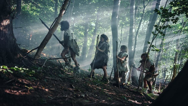 A depiction of a Neanderthal family wandering through the jungle.