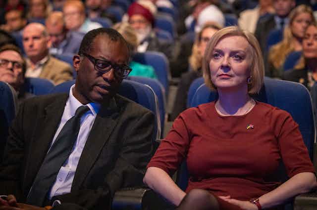 Kwasi Kwarteng, Liz Truss in the front row of an audience at the Conservative Party Conference, October 2022