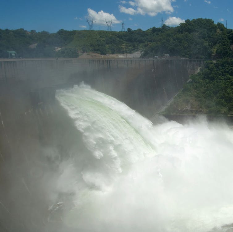 Tonnes of water gush out of a damaged dam wall.