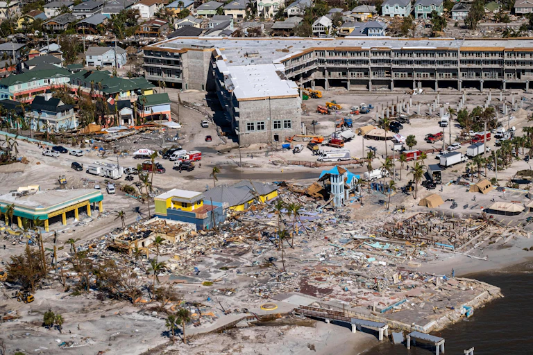 A beachfront town after a big disaster destroys buildings and other structures.