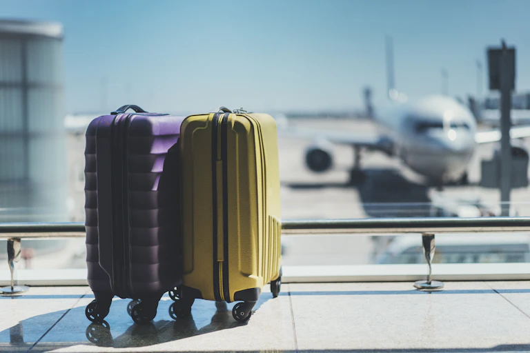 A pair of suitcases in the departure lounge of an airport.