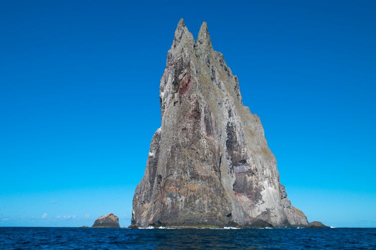 A jagged shard of rock stretching up from the surface of the ocean