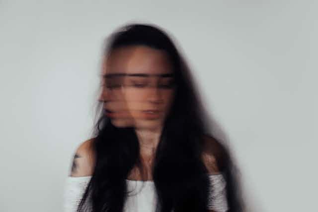 Blurred image of young woman's head and shoulders
