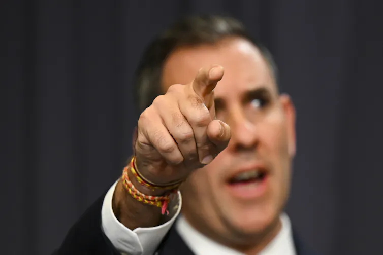 Man pointing while speaking