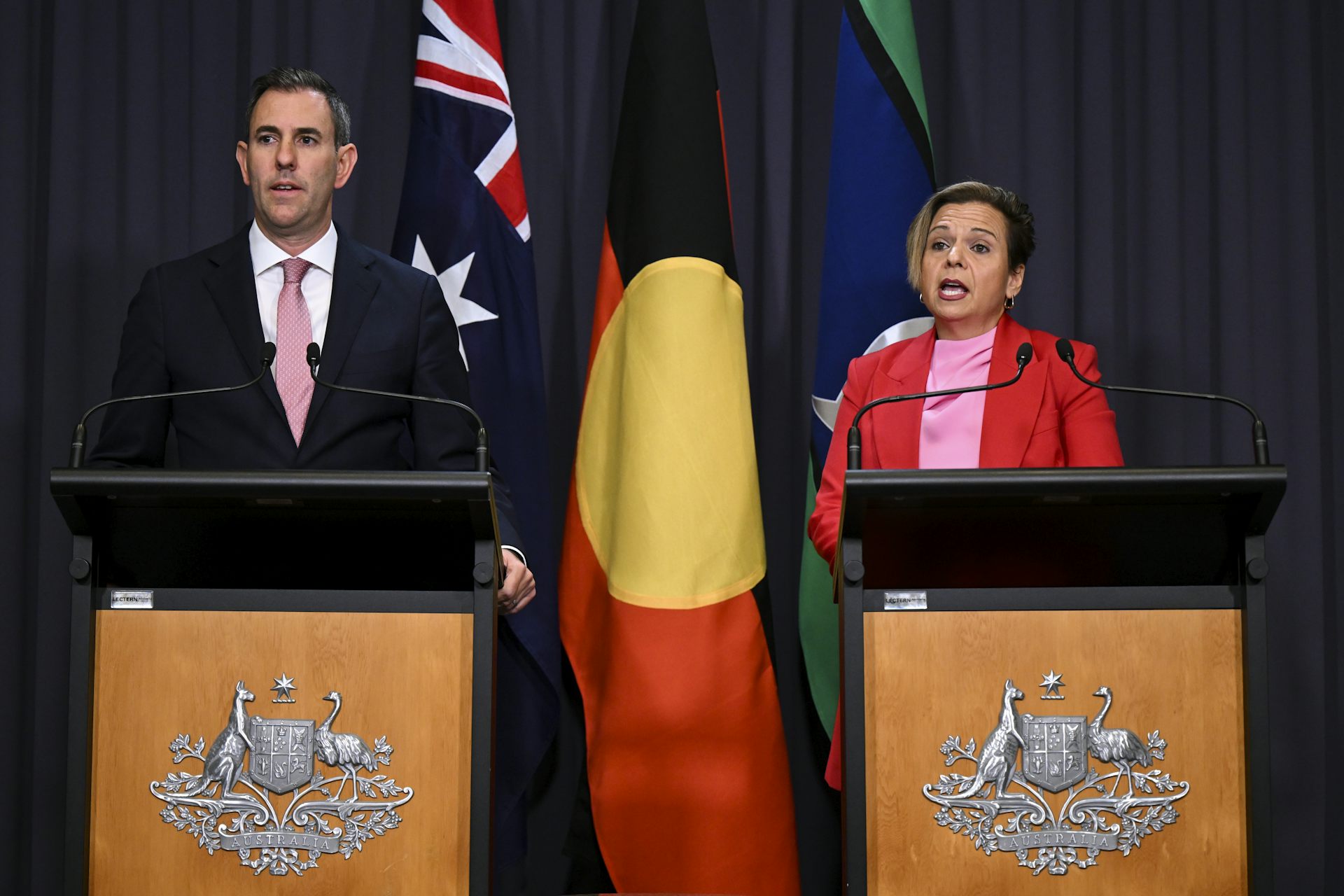 Man and woman speaking at podium