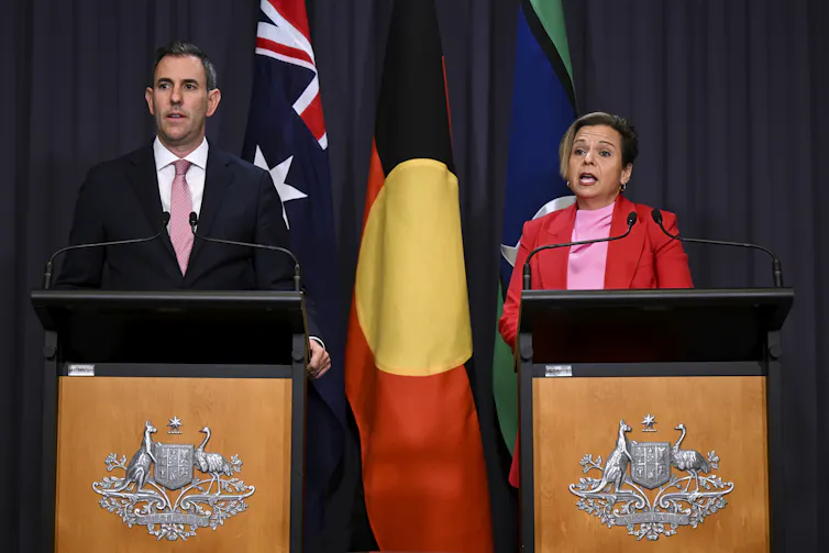 Man and woman speaking at podium