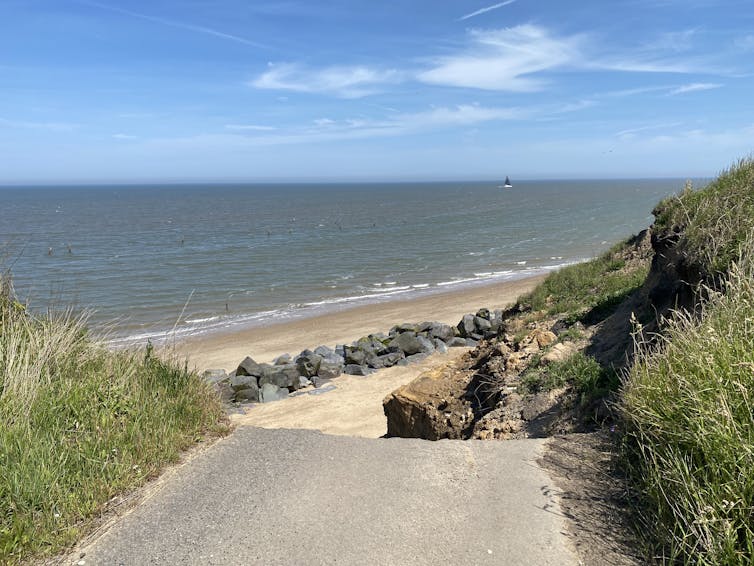 A paved road ending in a sheer cliff edge.