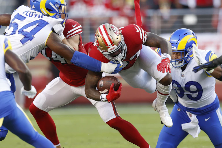 American footballers clashing on the field.
