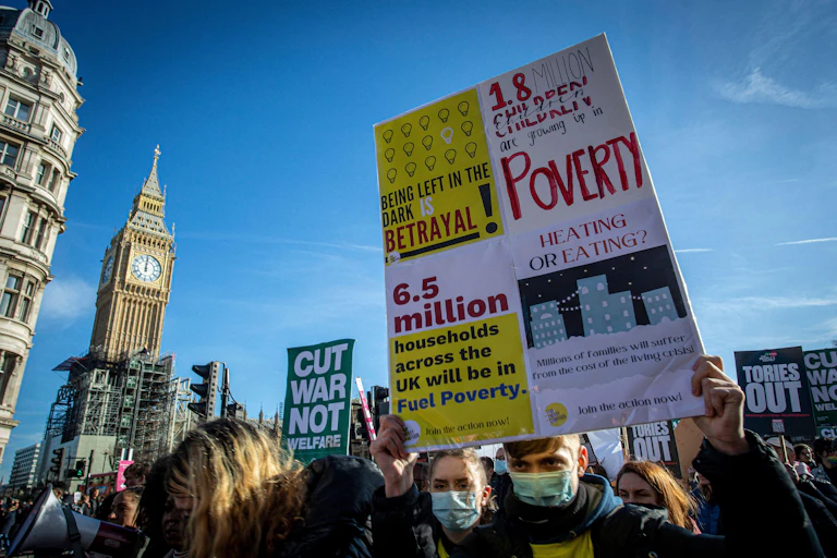 People protest with banners in a city centre.
