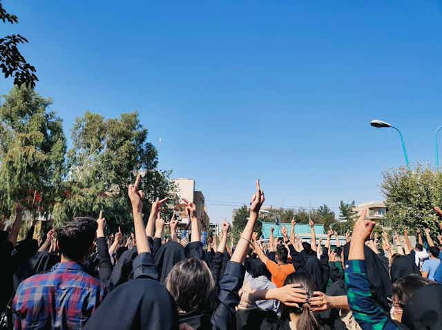 Photograph of student protests in Isfahan, Iran, taken from the back to avoid identification.