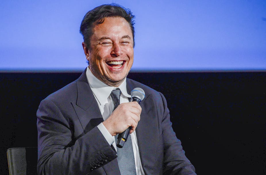 Elon Musk, microphone, blue and black background