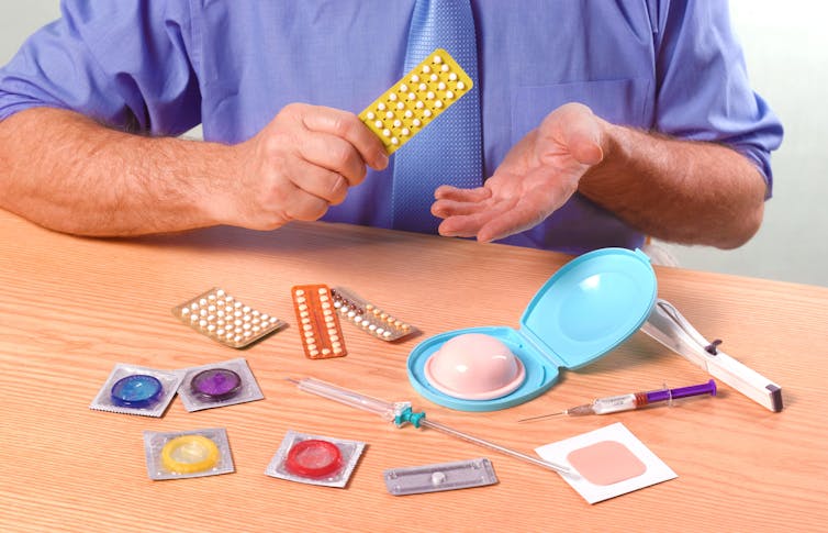 Person displaying a variety of birth control methods.