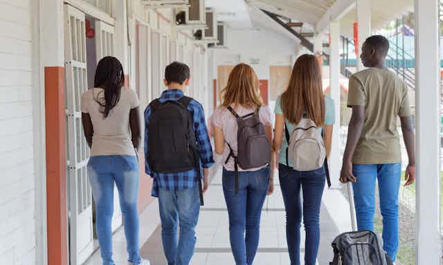 A group of students seen walking in a hallway.