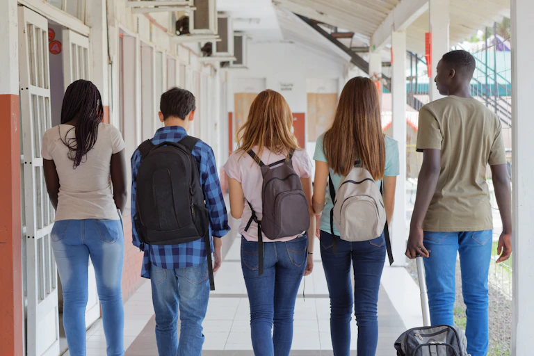 A group of students seen walking in a hallway.