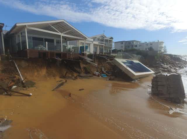 Erosion and a damage swimming pool by a beach house 