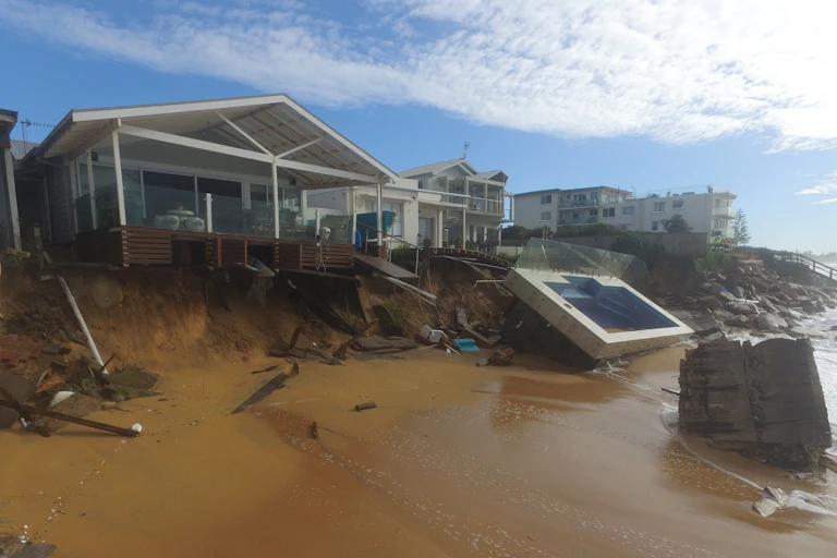 Erosion and a damage swimming pool by a beach house