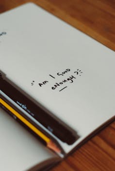 Notebook with message, 'am I good enough?'