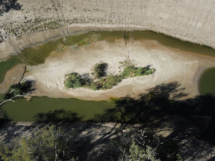 a dry river bed with green water
