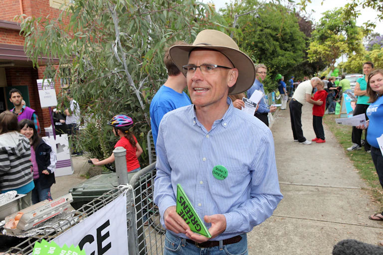 Clive Hamilton, a man in a shirt and belted jeans, with an Akubra, wearing a Greens badge