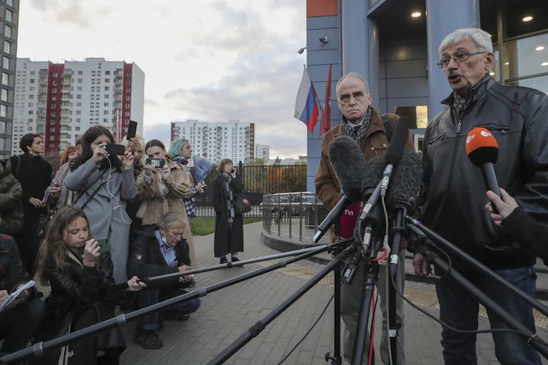 Two board members of Russian human rights organisation 'Memorial' speaking to the media