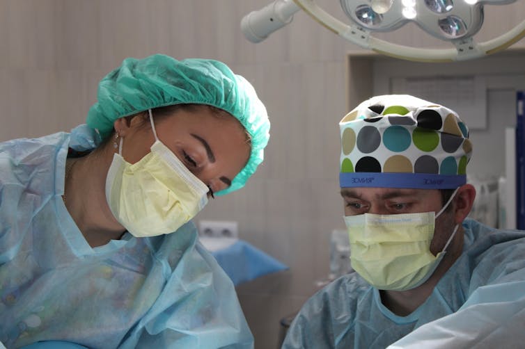 Two surgeons operating