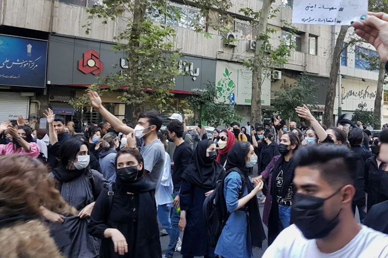 Young Iranians protesting in Tehran over the death of a young woman at the hands of the morality police, October 2022.