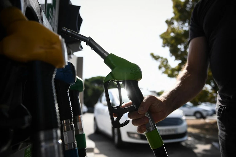 A man fills up at a petrol station.