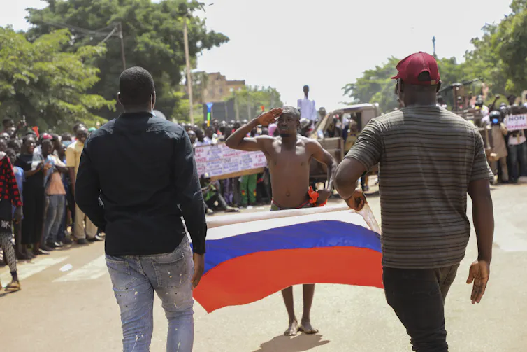 A man salutes the Russian flag during a rally in support of the coup in Ouagadougou, Burkina Faso, 02 October 2022.