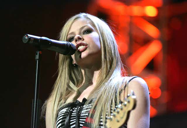 Avril Lavigne sings on stage.
