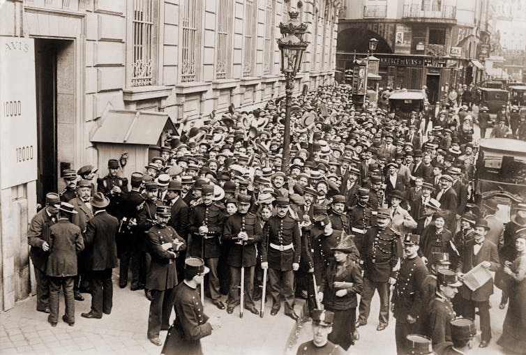 Police controlling an angry crowd during a Paris bank in 1904