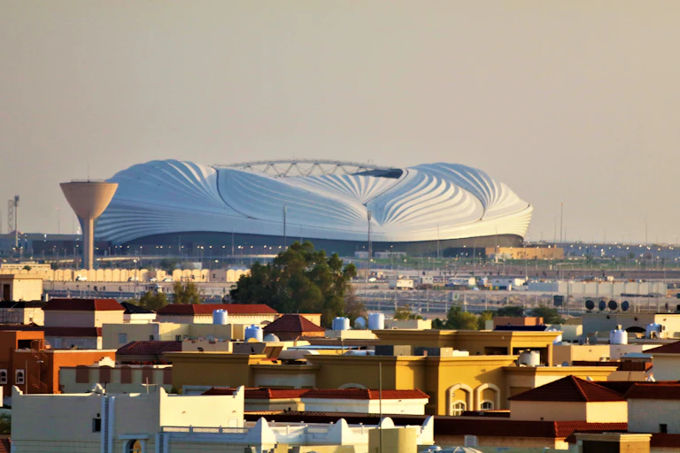 City view with modern stadium on horizon.