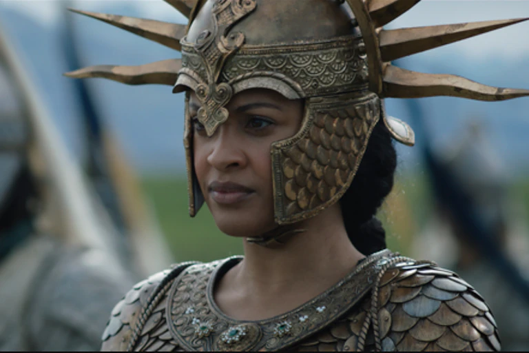 A woman in a helmet with large spikes and body armour.