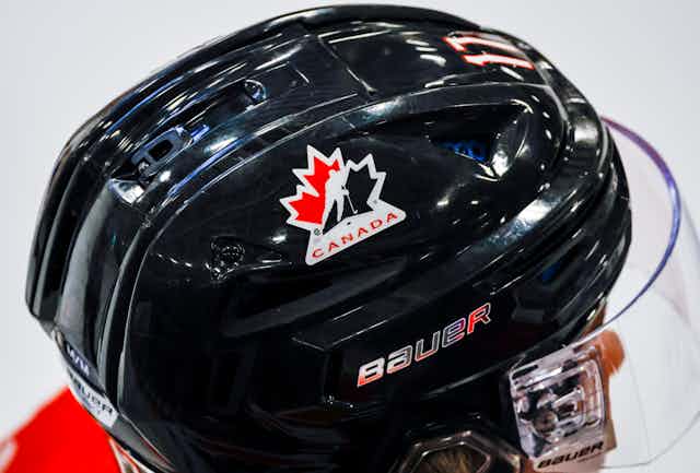 A black hockey helmet with a Canada emblem