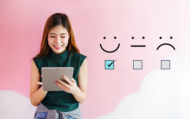 A person filling out a digital survey next to a row of response options.
