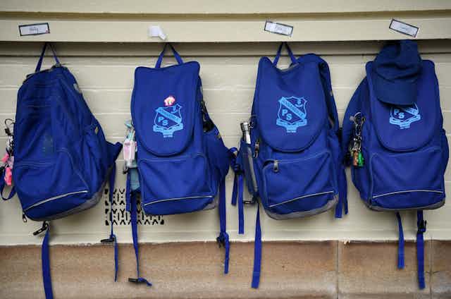 Schools bags hanging up.
